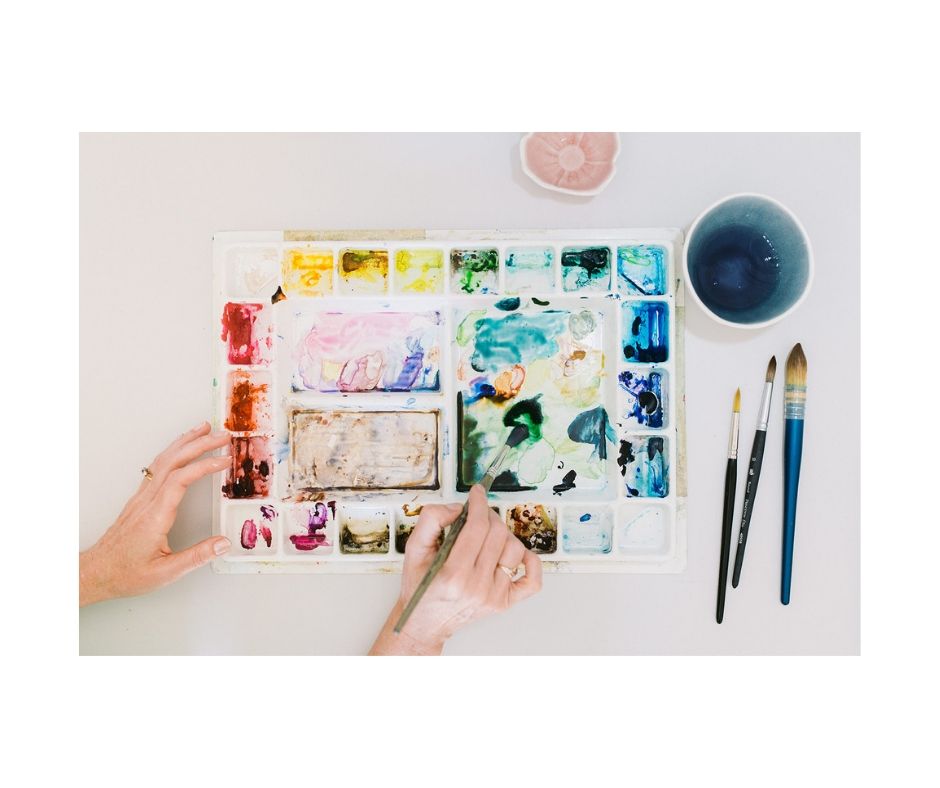 Artist mixing watercolours on palette 